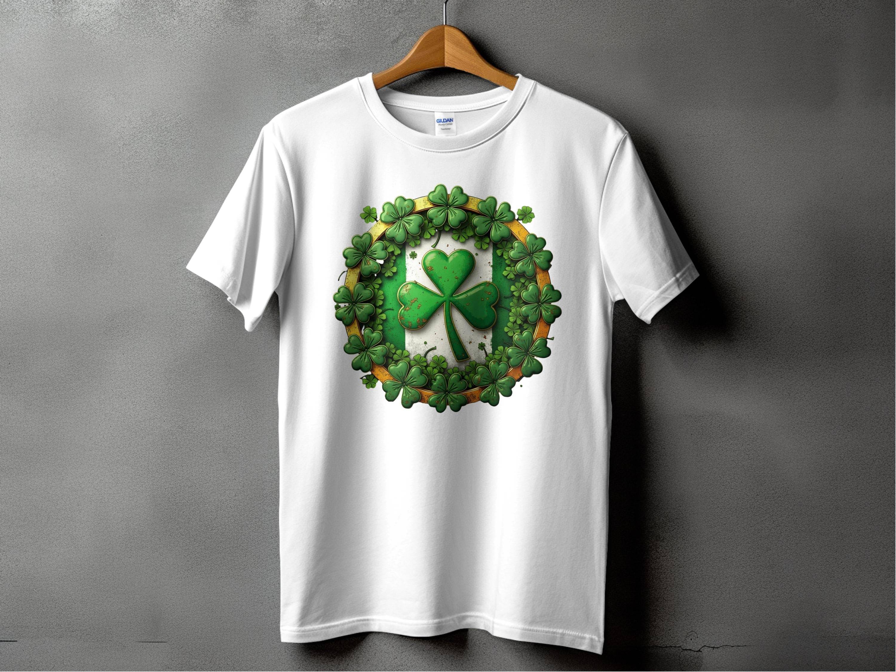 A Garment Graphics white graphic T-shirt hangs against a gray background, displaying a green shamrock clover encircled by smaller clovers—ideal for stylishly celebrating St. Patricks Day.