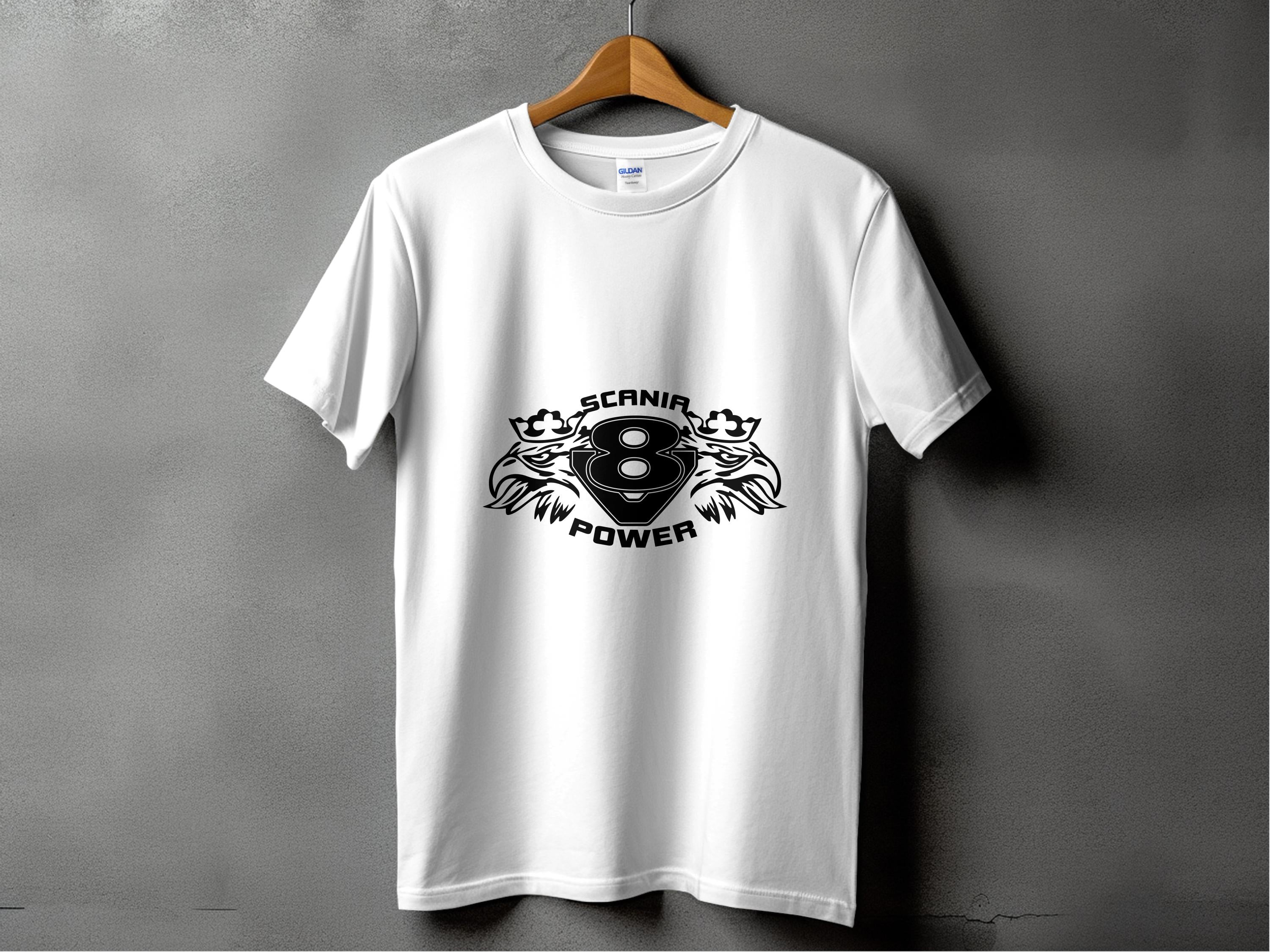A white T-shirt from Garment Graphics hangs on a wooden hanger against a gray wall, featuring a central black graphic with the bold text SCANIA POWER and a stylized 8, flanked by ornate griffins, embodying the essence of Scania Power Eagle.