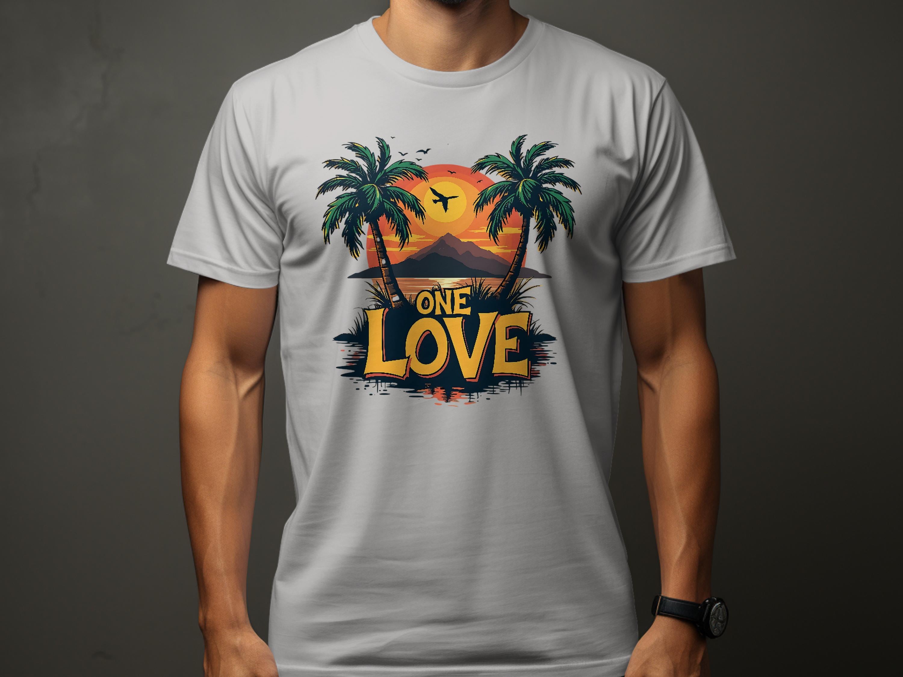 Wearing a light gray Garment Graphics T-shirt, one embraces the beach vibe with its bold ONE LOVE print, depicting two palm trees and a tropical sunset. A silhouetted bird flies over an island reflected smoothly in the water.