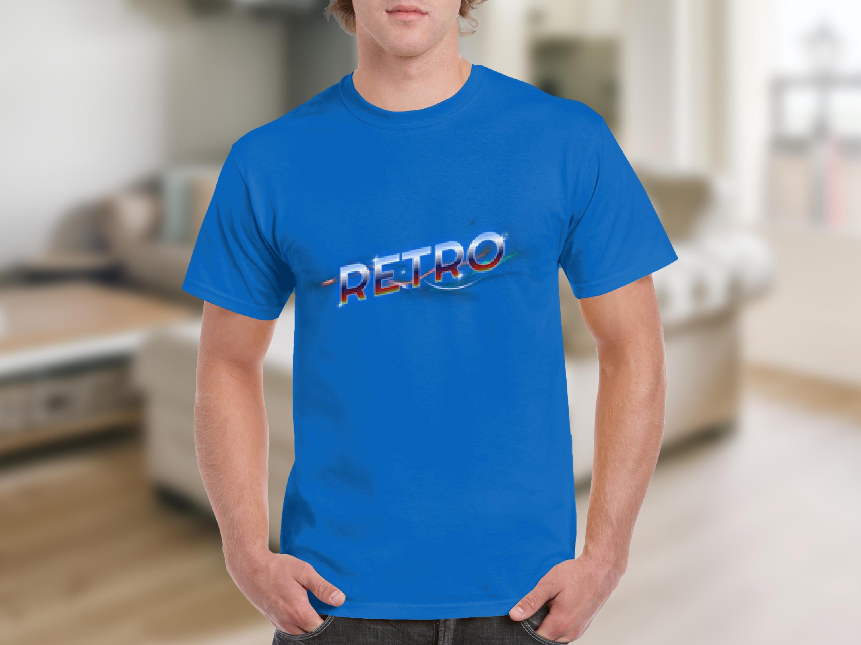 A person wears a bright blue t-shirt from Garment Graphics with RETRO printed on the front, exuding vintage charm. The background is a blurred interior, hinting at a classic fit in a cozy living room with furniture.