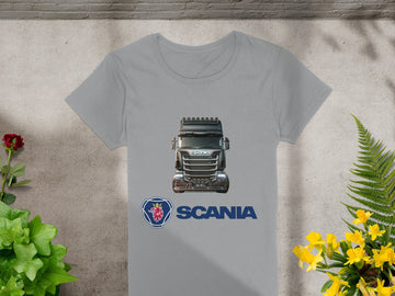 The Garment Graphics gray T-shirt showcases a semi-truck graphic with SCANIA underneath, ideal for automotive enthusiasts. Styled on a concrete surface with lively yellow and red flowers, this T-shirt combines rugged charm and style.
.