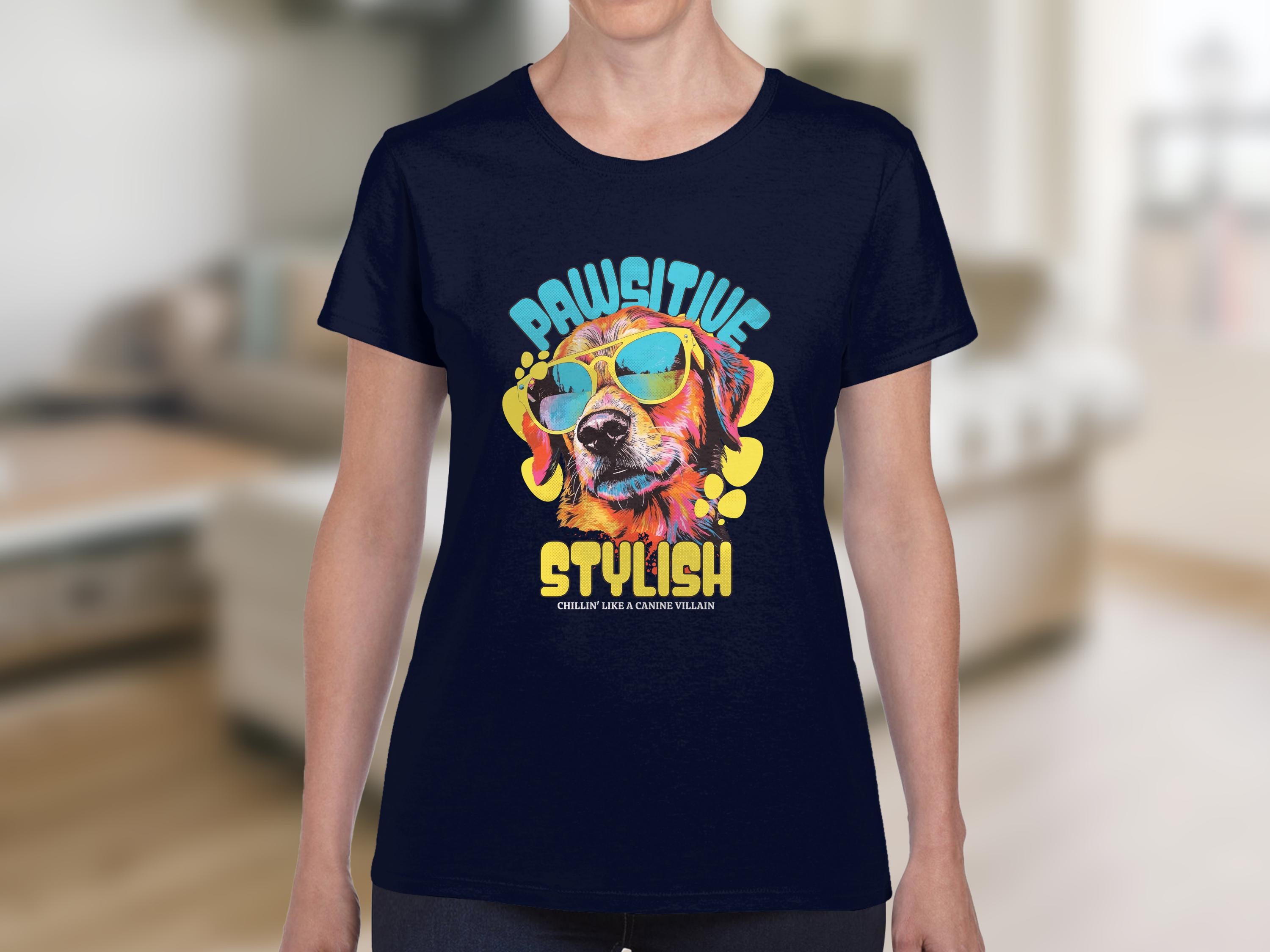 Sporting a Garment Graphics navy Dog T-Shirt, someone flaunts a vibrant dog illustration with sunglasses, bold PAWSITIVE STYLISH, and CHEEKY LIKE A CANINE VILLAIN text. Ideal for those in search of Womens Sizing fashionable sunglasses T-shirts against an indoor backdrop.