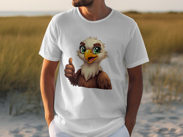 A person wears a classic fit white Garment Graphics Eagle T-shirt, featuring a cartoon eagle with big eyes giving a thumbs-up. Ideal for a fun casual wardrobe, theyre outdoors in a grassy area, enjoying the day.