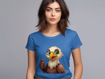 A woman with brown hair wears a Garment Graphics blue cartoon T-shirt featuring an eagle giving a thumbs up, ideal for animal lovers. The background is plain grey.