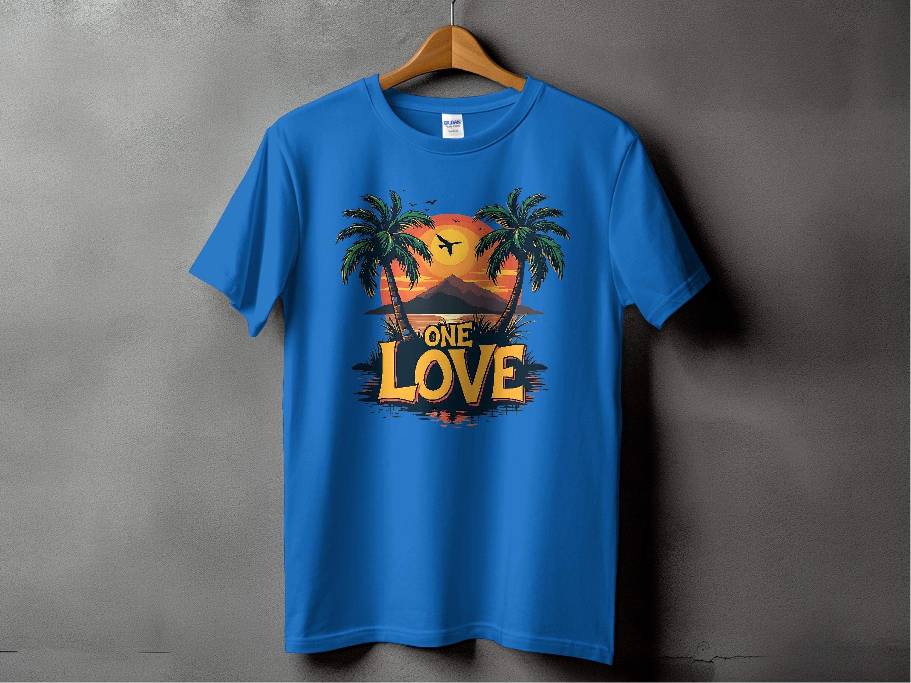 A blue T-shirt from Garment Graphics hangs on a wooden hanger against a gray background, featuring a tropical sunset design with palm trees, a bird in flight, and ONE LOVE boldly printed—ideal for beach enthusiasts.