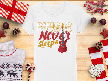 Garment Graphics presents a unique T-shirt with the inspiring Music Never Sleeps slogan and a bold red guitar print. Perfectly laid on a wooden surface, its surrounded by gifts and holiday decor—ideal for guitar T-shirt fans this season.