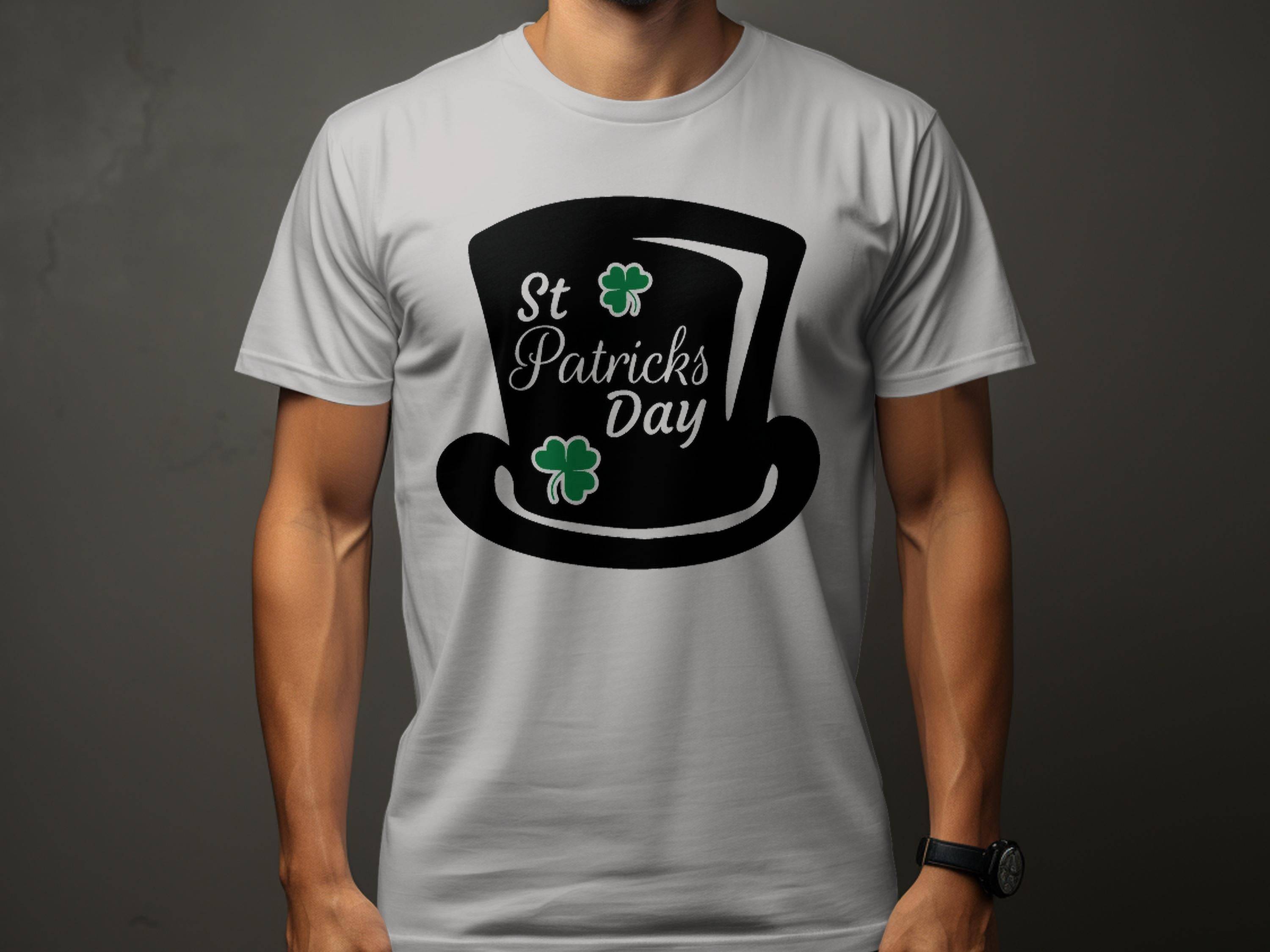 A person is wearing a Garment Graphics white T-shirt featuring a black top hat, St Patricks Day text, and two green shamrocks against a plain dark gray background, ideal for celebrating St Patricks Day.