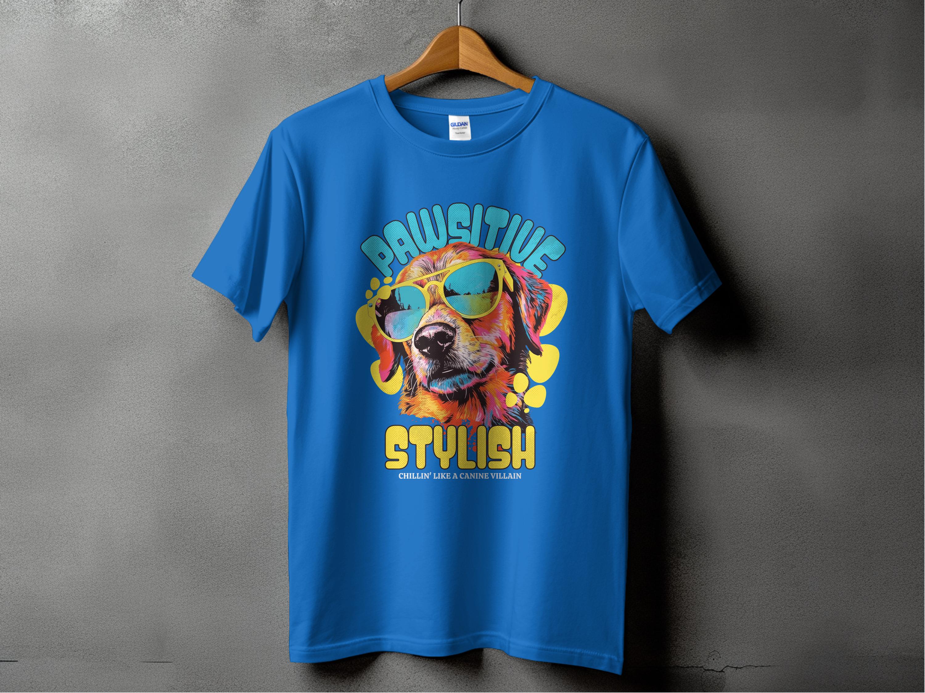The Garment Graphics Blue T-shirt features a dog in sunglasses with the text Chillin Like A Canine Villain on a colorful splash background, exuding Paw-sitive Stylish vibes from a hanger.