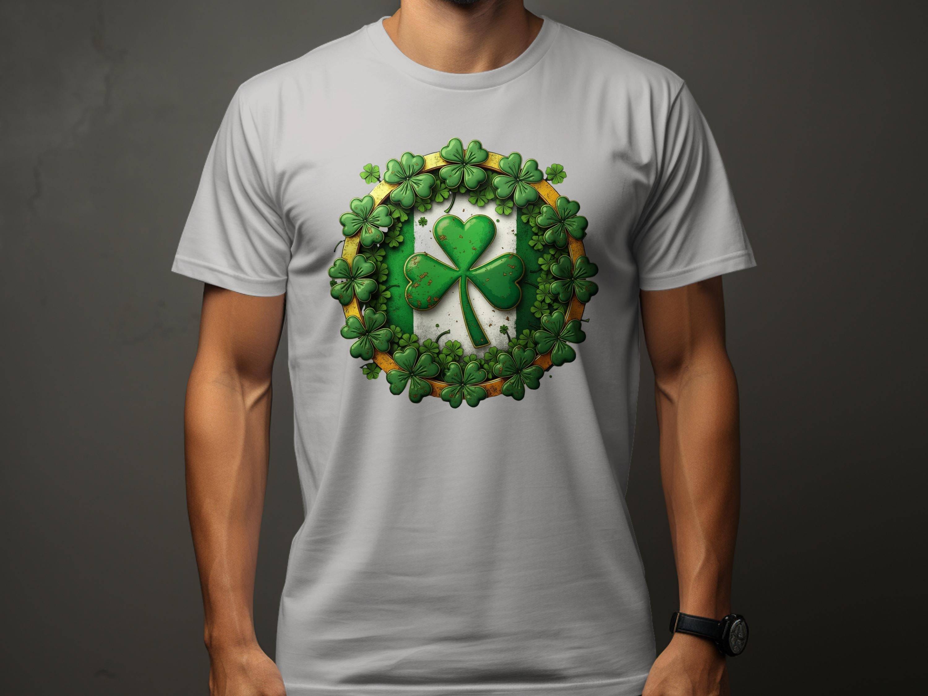 Someone is wearing a Garment Graphics T-shirt ideal for St. Patricks Day, showcasing a large shamrock clover with smaller shamrocks arranged in a circular pattern. Their arms are visible as they stand against a plain background.