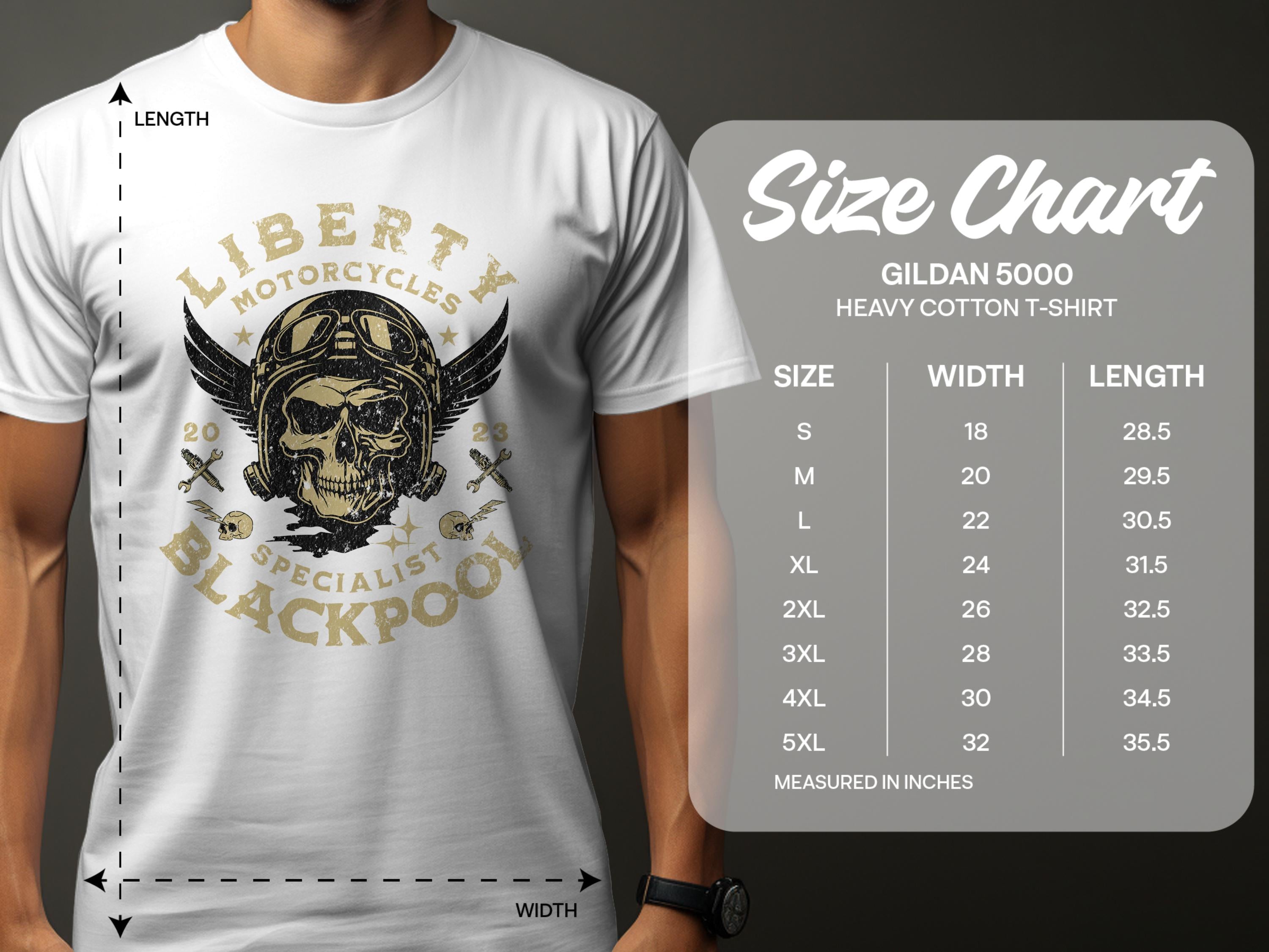 A person dons a Garment Graphics white t-shirt displaying a skull and wings with Liberty Motorcycles Specialist Blackpool text. Perfect for motorcycle fans, it exudes vintage flair. On the right, a Gildan 5000 t-shirt size chart shows sizes and measurements in inches.