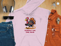 Brand Name: Garment Graphics

A light pink hoodie by Garment Graphics features a cartoon turkey with Turkey on the Run, laid out on wood next to jeans, sunglasses, headphones, a watch, keys, and an orange shirt. Ideal for casual outings!.