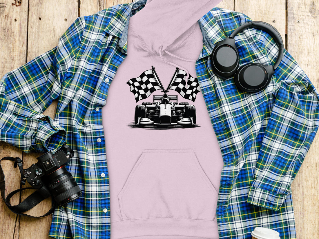 A motorsport enthusiast wears a Garment Graphics black hoodie featuring a race car with crossed racing checkered flags on a plain white background, offering style and flair.