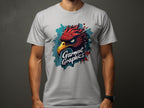 Someone is wearing a classic fit white T-shirt from Garment Graphics, featuring an eagle head with red and dark blue feathers. The shirt displays Garment Graphics below the eagle and contrasts sharply with a plain, dark background.