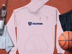 A light pink Garment Graphics hoodie with SCANIA above a logo, set on a textured surface, pairs stylishly with black shorts, an orange basketball, a clear water bottle, and a white towel for athletic days.