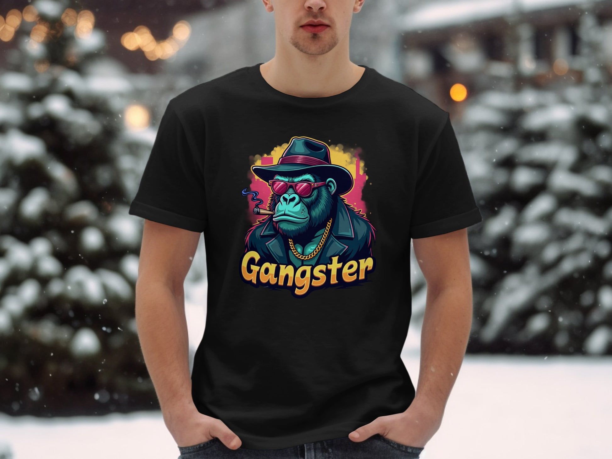 In an urban snowy setting, a person wears Garment Graphics black t-shirt featuring a colorful graphic of a chimpanzee in gangster attire with Gangster boldly printed below, embodying the classic fit essence.