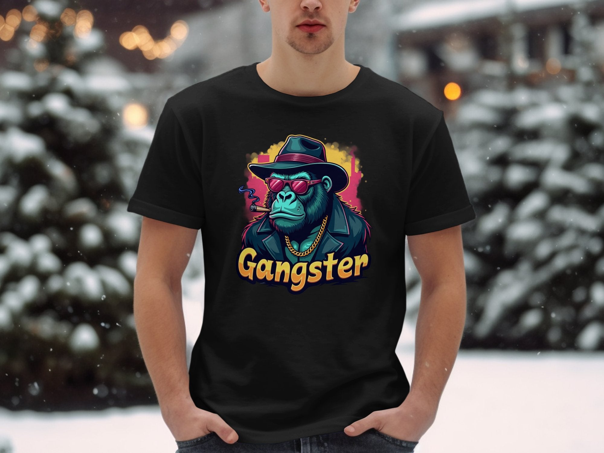 In an urban snowy setting, a person wears Garment Graphics black t-shirt featuring a colorful graphic of a chimpanzee in gangster attire with Gangster boldly printed below, embodying the classic fit essence.