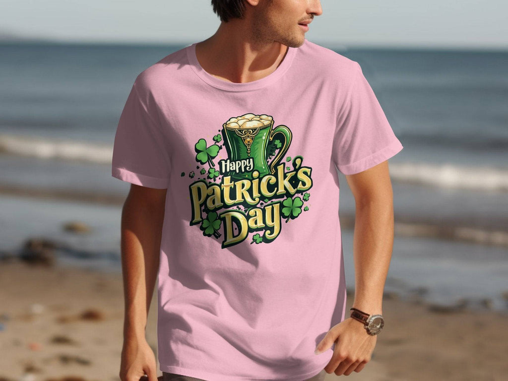 On a serene beach, someone makes a bold statement wearing a festive pink Garment Graphics T-shirt that says Happy Patricks Day, adorned with beer mugs and shamrocks.