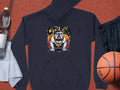 A Garment Graphics dark hoodie featuring a bold Bulldog Design and CITY KING text lies on a sports court, surrounded by casual essentials like a towel, water bottle, black shorts, and a basketball—ideal for classic fit moments.