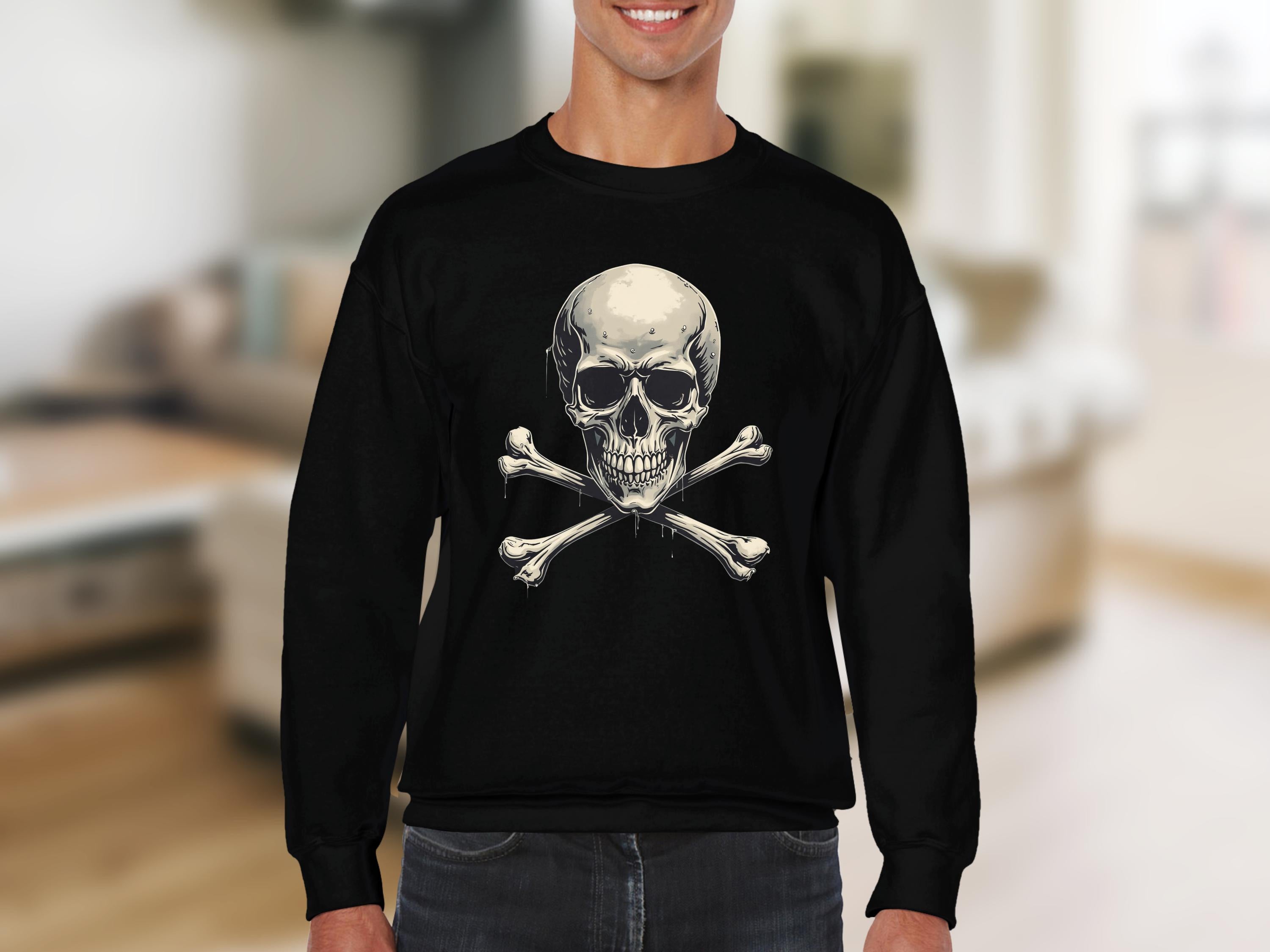 Someone is donning a bold, edgy black sweatshirt from Garment Graphics with a skull and crossbones design. The background is a softly blurred interior room featuring light-colored furniture.