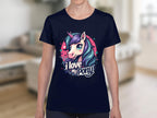 A person wears a Garment Graphics navy T-shirt with a vibrant unicorn and pony design, plus the text I Love My Pony, ideal for unicorn fans. The background is a blurred indoor setting.