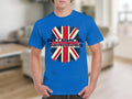 A person wears a classic fit blue Garment Graphics T-shirt with a Union Jack design and the bold statement: DONT BLAME ME, I Didnt Vote For Him, standing in a room with a blurred background.