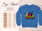 Garment Graphics presents a blue Gildan 18000 Heavy Blend Crewneck featuring vibrant I Love Graffiti text. Available in sizes S to 5XL, with dimensions in inches listed on the left. A subtle leaf pattern enhances its street art vibe.