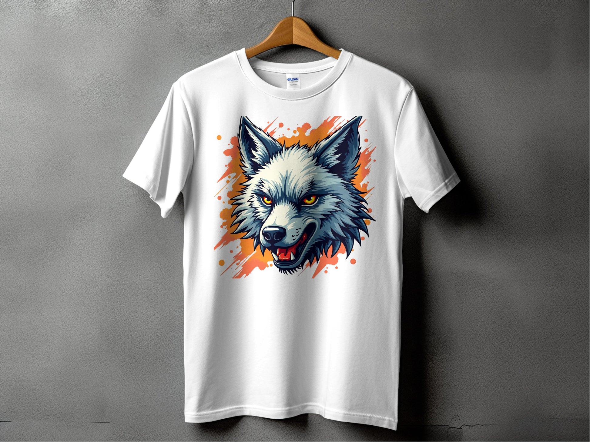 A stylish Garment Graphics T-shirt hangs on a wooden hanger, featuring a vivid wolf graphic against an abstract orange splash. Ideal for fearless personalities, it pops beautifully against the gray wall backdrop.