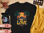 Flat lay showcasing a black Garment Graphics shirt with a vibrant One Love Sunset palm tree design, complemented by a yellow blazer, eyeshadow palette, makeup brushes, sunglasses, red lipstick, blue pouch, and pink shoes—all artfully arranged on a wooden surface.