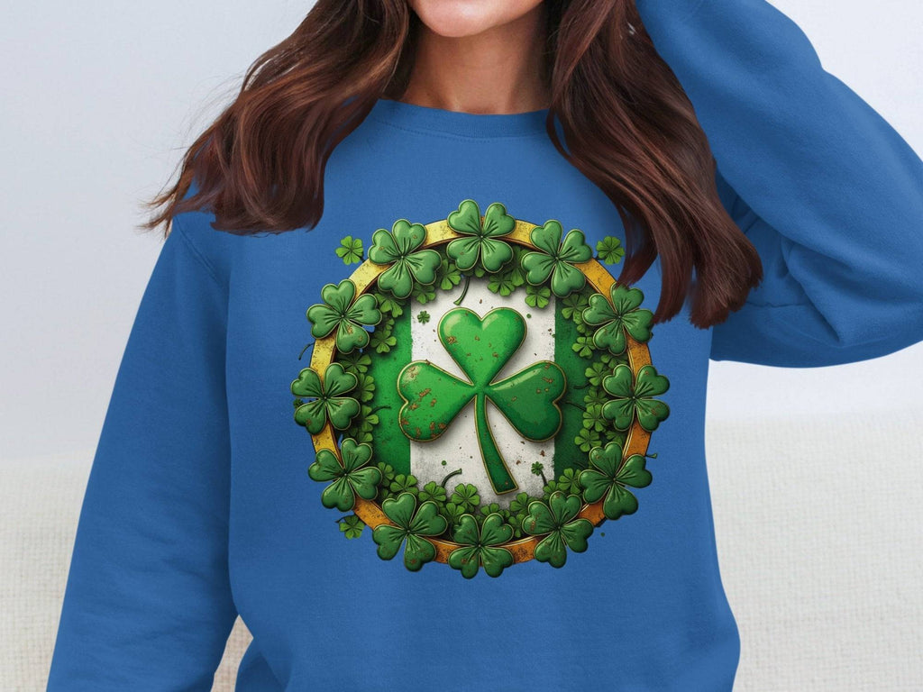 Someone is wearing a Garment Graphics sweatshirt with a blue circle design featuring green shamrocks around a central four-leaf clover. The circle has a white background with a gold border, capturing the Irish spirit perfectly.