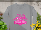 Gray sweatshirt from Garment Graphics featuring a pink Beach Girl graphic with three cartoon women in swimwear and palm trees. The text reads Always Party Beach Girl Garment Graphics, laid flat beside vibrant green and yellow plants.