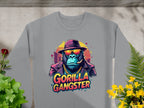 The Garment Graphics urban style gray sweatshirt showcases a gorilla in a hat, sunglasses, gold chain, and cigar, with Gorilla Gangster boldly printed below. Ideal for an edgy look when paired with potted plants on a concrete surface.