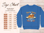 A size chart for Garment Graphics Gildan 18000 Heavy Blend Crewneck Sweatshirt, unisex sizes S-5XL with widths and lengths, is on the left. On the right, a blue sweatshirt features a playful pie character and text: Hot & Spicy. You Wanna a Piece of Me?.