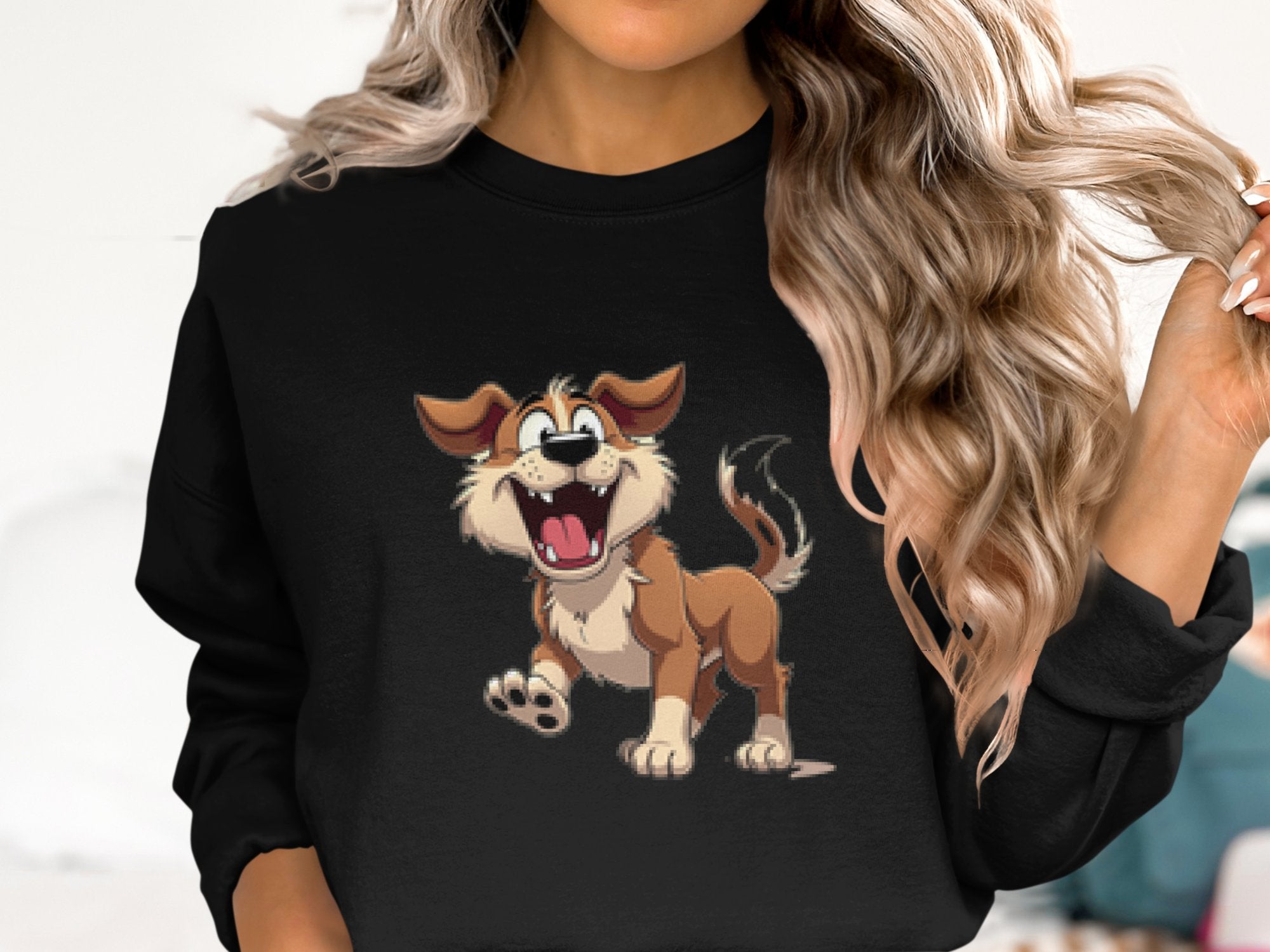 A person with wavy blonde hair is wearing a black Garment Graphics sweatshirt, perfect for dog lovers, featuring a cheerful animated illustration of a brown and white pup with an open mouth and wagging tail.