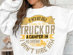 A person, shown from neck to waist, wears a humorous Garment Graphics sweatshirt. The text says: If hes got golf clubs in his truck or a camper in his driveway, I dont hire him in yellow and brown fonts.