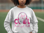 A fashion lover showcases a white Garment Graphics sweatshirt with pink and gray Rock and Roll headphones, featuring the text Just be cool Rock and Roll, ideal for music enthusiasts.