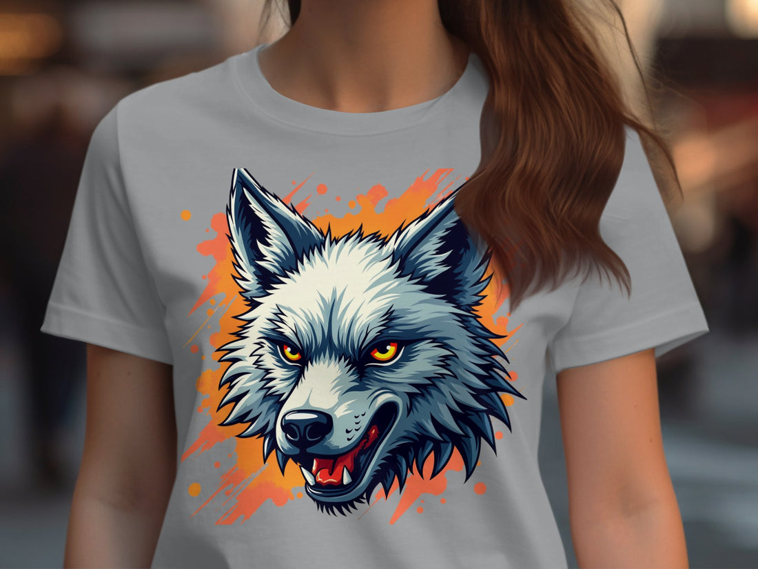 Garment Graphics 100% cotton white T-shirt showcases a bold wolf with piercing eyes and an open mouth on a vibrant brushstroke backdrop. Surrounded by wrapped gifts, a sweater, candy, pinecones, and holiday decorations on wood.