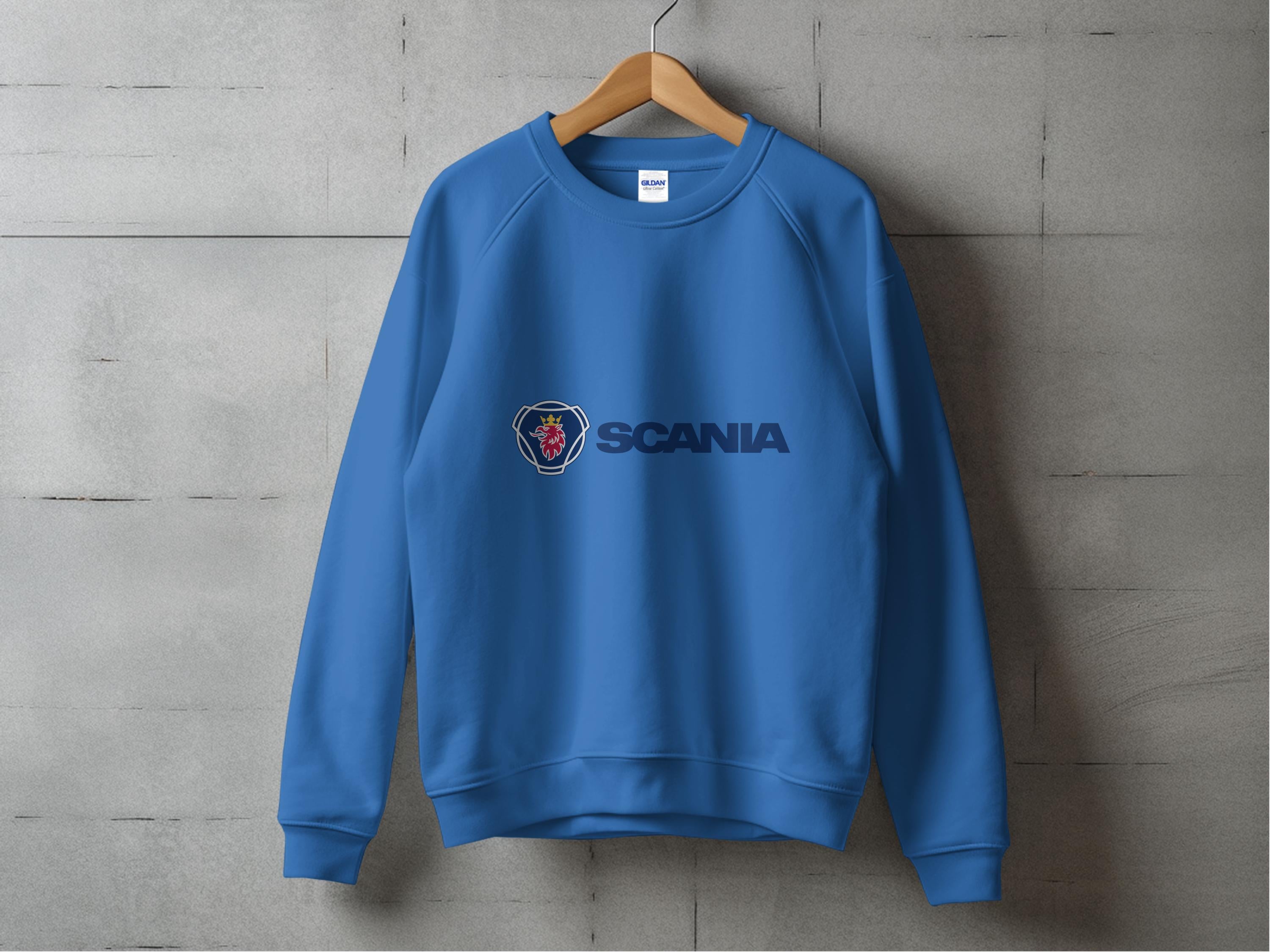 This Garment Graphics blue sweatshirt, ideal for casual outings, features a bold dark blue Scania and stylized griffins head logo on a concrete backdrop. Its unisex design and industrial-chic style make it a versatile addition to any wardrobe.