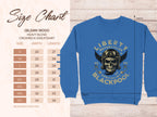 Garment Graphics offers a blue crewneck sweatshirt with a skull and motorcycle helmet graphic labeled Liberty Motorcycles Specialist Blackpool 2023. Available in sizes S to 5XL, it includes a size chart detailing precise width and length measurements.