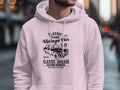 A person wears a white hoodie from Garment Graphics showcasing a vintage car with Classic London City Vintage Car Club and Classic Garage Old School Automotive text. Perfect for car enthusiasts, it also features the phrase High Life & Cool Vibe against a blurred city street backdrop.