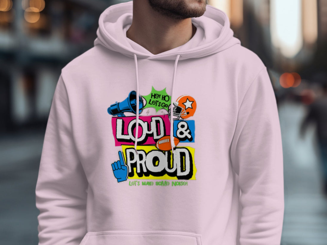 The Lets Make Some Noise hoodie by Garment Graphics showcases vibrant slogans like Hey Ho Lets Go and Loud & Proud, highlighted with microphone, star, and hand icons. Displayed on a wooden surface with Christmas decor and coffee, its ideal for adding festive flair to any moment.