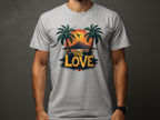 Wearing a light gray Garment Graphics T-shirt, one embraces the beach vibe with its bold ONE LOVE print, depicting two palm trees and a tropical sunset. A silhouetted bird flies over an island reflected smoothly in the water.