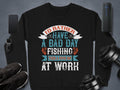 The unisex black fishing sweatshirt from Garment Graphics displays the text: Id rather have a bad day fishing than a good day at work. Its styled with a phone, smartwatch, shoes, speaker, and dumbbells on a gray surface—ideal for any fishing enthusiast.