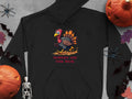 Garment Graphics offers a black hoodie with a cartoon turkey and Turkey On The Run in bold red text. This funny design features pumpkins, a skeleton, bats, and two plastic spiders on a gray background.