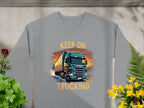 Perfect for truck enthusiasts, Garment Graphics offers a gray sweatshirt featuring a large truck on a road. Adorned with bold orange KEEP ON TRUCKING text, its surrounded by green plants and yellow flowers, making it a unique piece in Graphic Sweatshirts.