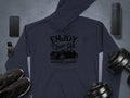 Flat lay of Garment Graphics classic fit dark blue hoodie with a vintage car design, surrounded by a smartphone, smartwatch, wireless speaker, black sneakers, and adjustable dumbbells on a gray surface. Ideal for those with community spirit who cherish timeless style.