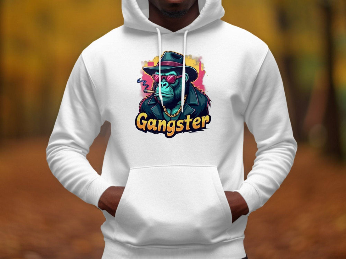 Adopt a smokey cool style with Garment Graphics black hoodie, featuring a vibrant gangster gorilla graphic. Made from medium-heavy fabric, its ideal for chilly days amidst holiday décor like pine cones, ornaments, and a steaming coffee cup on a wooden table.