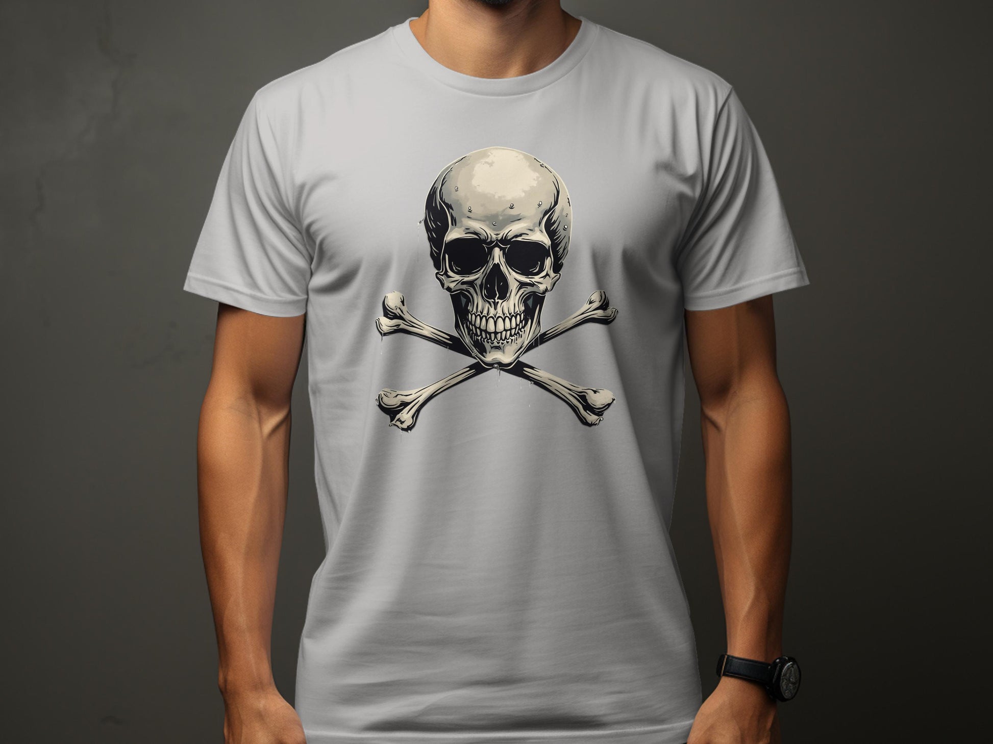 Wearing a Garment Graphics light gray graphic t-shirt with a bold skull and crossbones design, a person makes a fashion statement. The plain dark gray background highlights the striking imagery as they stand with their arms by their sides.
