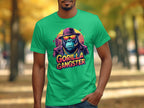 Wearing Garment Graphics green T-shirt, a person stands out with a GORILLA GANGSTER print featuring a gorilla in a hat, sunglasses, and necklace. The backdrop of blurred trees and paths enhances the T-shirts edgy style.