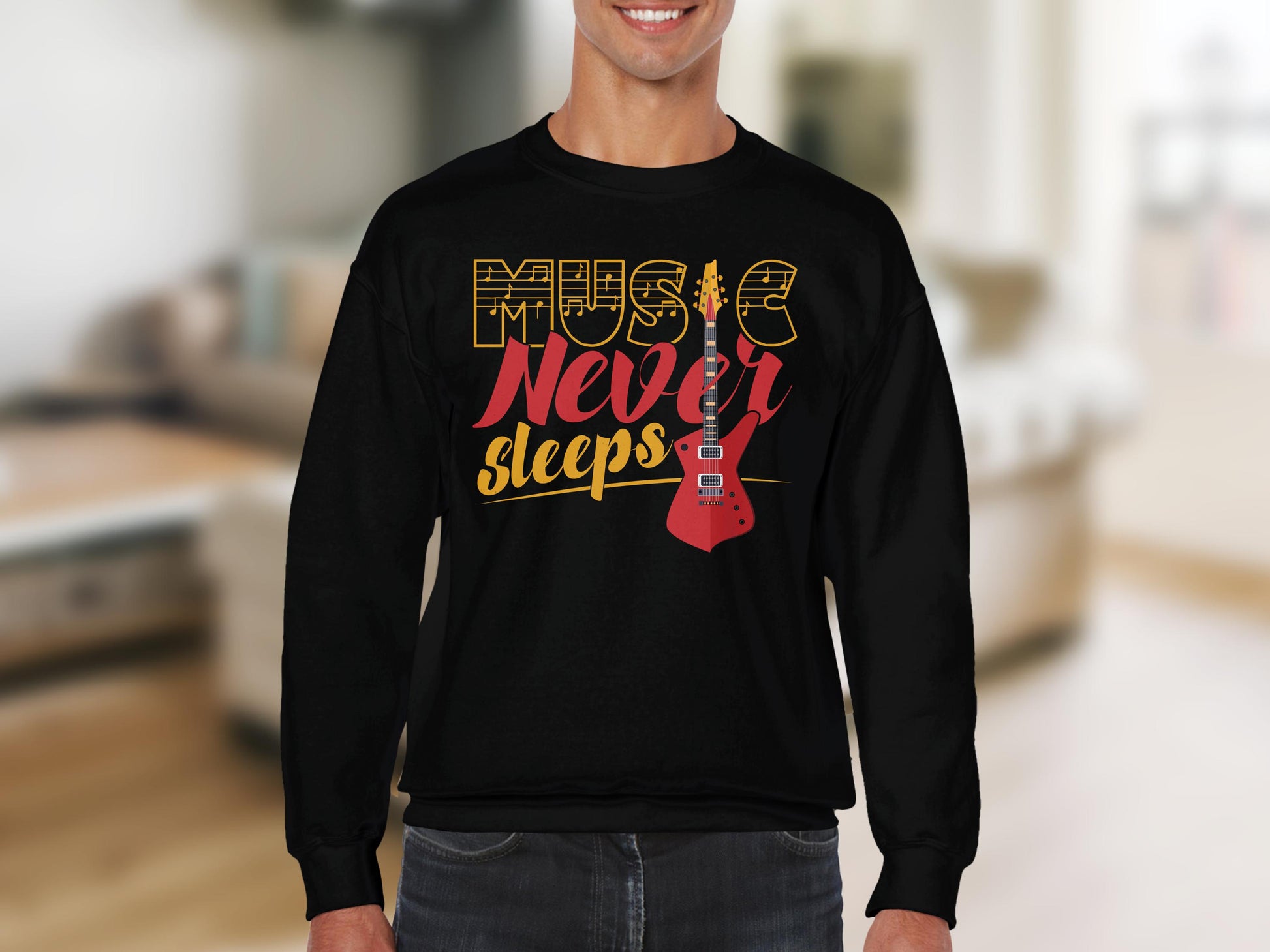 A vibrant individual dons a Garment Graphics black sweatshirt with Music Never Sleeps in yellow and red, featuring a red electric guitar design. Perfect for music fans, its highlighted against a softly blurred indoor scene.