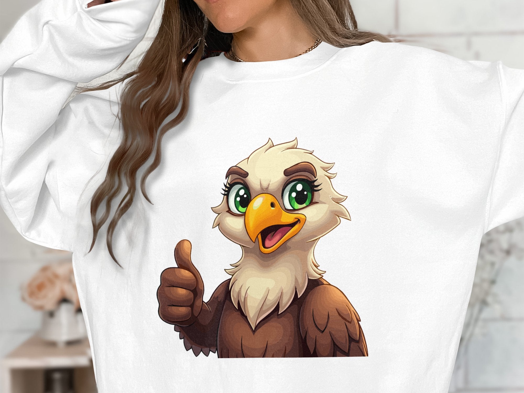 Wearing a Garment Graphics sweatshirt with a lively cartoon eagle sporting green eyes and giving a thumbs-up, this person embraces fun. The unisex fit allows everyone to enjoy its charm, though the persons face is partly out of frame.